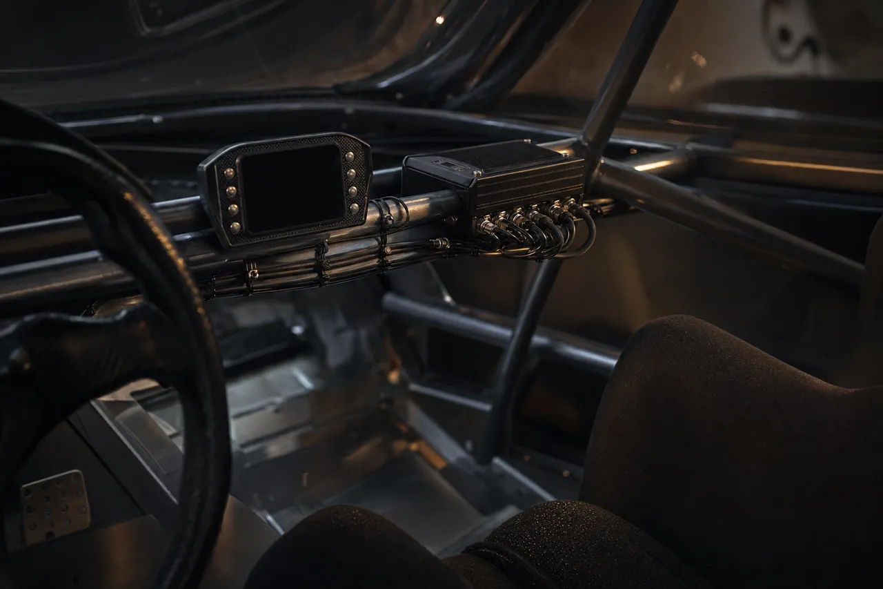 Telemetry and logging hardware installed in a race car cockpit.